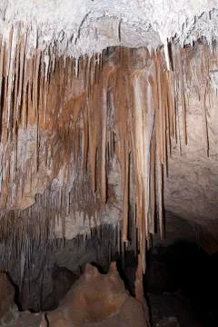 Stalactites hanging from cave ceiling Stock Photos