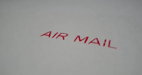 A stamp AIR MAIL is placed on a sheet of white paper, close-up Stock Footage 251589195