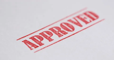 A stamp Approved is placed on a sheet of white paper, close-up Stock Footage 162716490