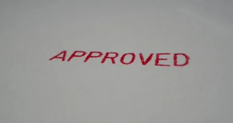 A stamp APPROVED is placed on a sheet of white paper, close-up Stock Footage 251589209