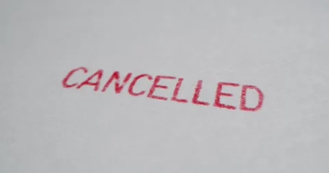 A stamp CANCELLED is placed on a sheet of white paper, close-up Stock Footage 251589479