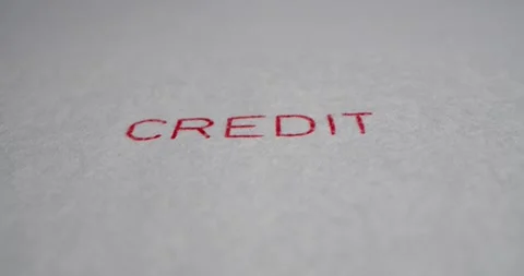 A stamp CREDIT is placed on a sheet of white paper, close-up Stock Footage 251589070