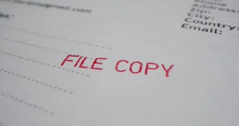 A stamp FILE COPY is placed on a sheet of white paper, close-up Stock Footage 251588453