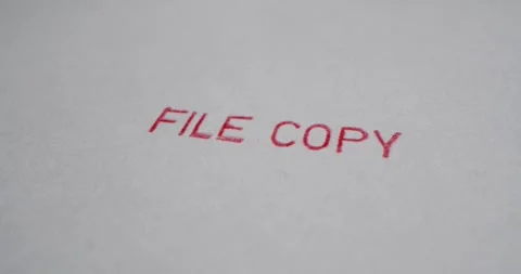 A stamp FILE COPY is placed on a sheet of white paper, close-up Stock Footage 251588614