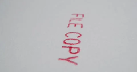 A stamp FILE COPY is placed on a sheet of white paper, close-up Stock Footage 251589328