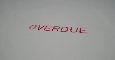 A stamp OVERDUE is placed on a sheet of white paper, close-up Stock Footage 251589117