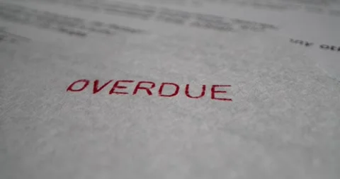 A stamp OVERDUE is placed on a sheet of white paper, close-up Stock Footage 251589276
