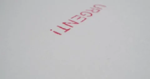 A stamp URGENT is placed on a sheet of white paper, close-up Stock Footage 251589319