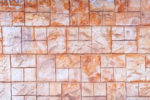 Stamped concrete wall displaying a rustic texture and natural block pattern Stock Photos