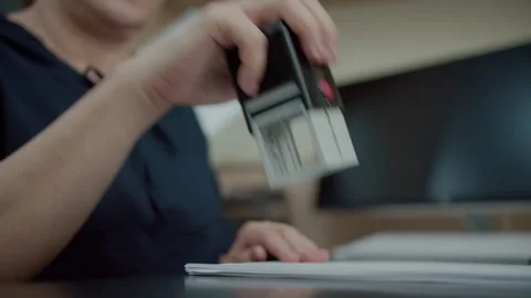 Stamping document at office desk Stock Footage 311183138