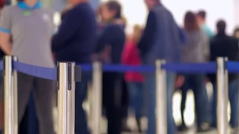 Stanchion barriers and passengers in front of information check-in desks on Stock Footage 82283446