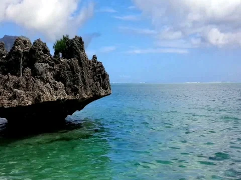 A stand alone rock in Mauritius coastal line Stock Footage