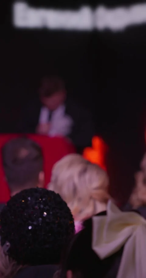 A stand-up artist during his performance in a dark room behind a red pedestal Stock Footage 268828133