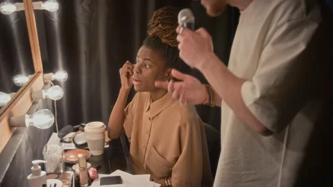 Stand-Up Artist Rehearsing Performance, While his Colleague Doing her Make-Up Stock Footage 307612493