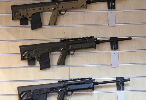 Stand with automatic rifle. Weapons Stock Photos