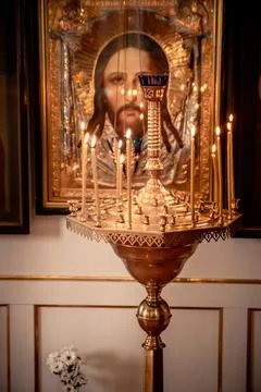 Stand with candles in front of a large icon in the church Stock-Fotos