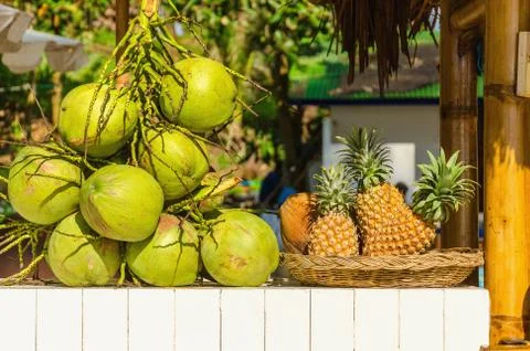 Stand with coconuts and pineapples Stock Photos