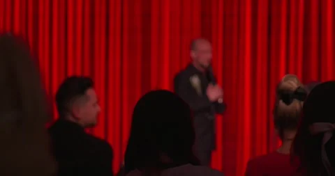 A stand-up comedian's performance on stage in front of an audience Stock Footage 272606715