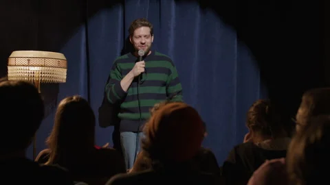 Stand Up Comic Speaking to Audience during Performance at Comedy Club Stock Footage 333227427