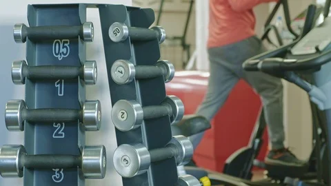 Stand with dumbbells in the gym Stock Footage 107574666
