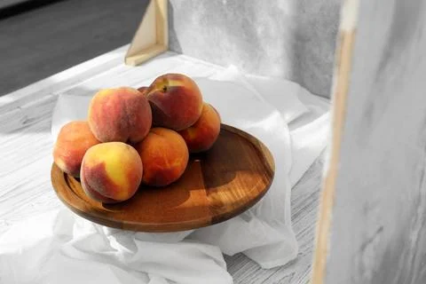 Stand with juicy peaches and double-sided backdrops in photo studio Stock Photos
