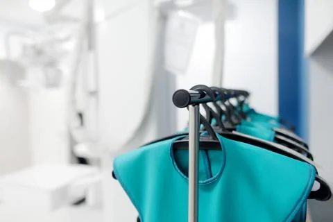 A stand with lead aprons which using for protection from radiation in X-ray.. Foto stock