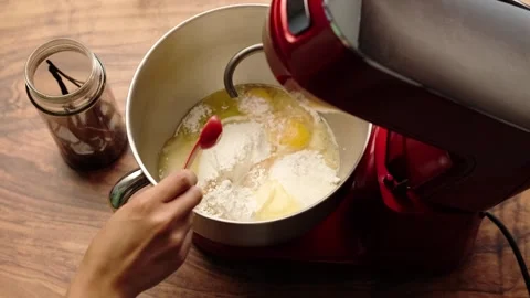 Stand mixer, adding a teaspoon of natural vanilla essence Stock Footage 281459974