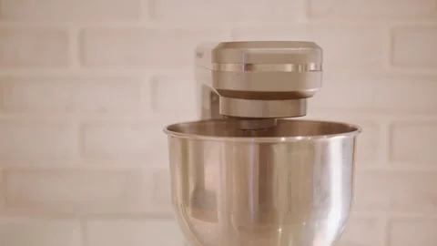 Stand mixer awaiting pumpkin pie in clean stainless bowl, brick wall backdrop Stock Footage 346394328
