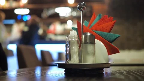 A stand with napkins on the table in a cafe with a blurred bokeh. the people in Stock Footage 169953675