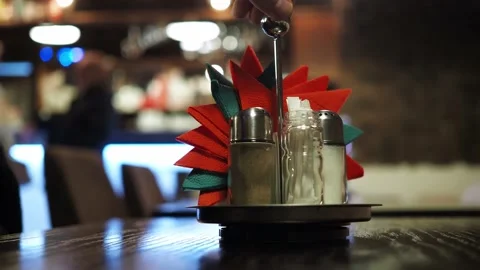 A stand with napkins on the table in a cafe with a blurred bokeh. the people in Stock Footage 170446788