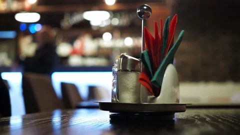 A stand with napkins on the table in a cafe with a blurred bokeh. the people in Stock Footage 170566424