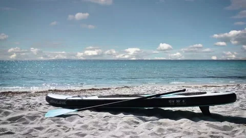 Stand UP Paddle Board lying on the sand Stock Footage 153159798