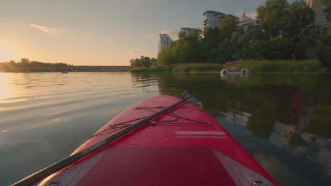 Stand Up Paddle Board POV View at Golden Hour Sunset | Paddling on Calm River Stock Footage 344086826