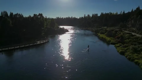 Stand Up Paddle Boarding On River with Bright Sunlight an Contrast Dark Stock Footage 249748485