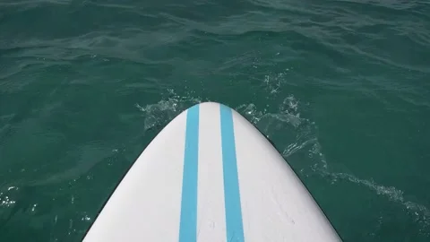 Stand Up Paddle Floating On The Water. Waves Splashing On The Board Stock Footage 153159815