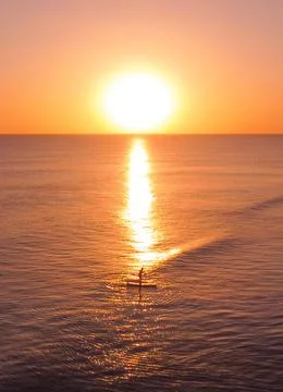 Stand up Paddle SUP in the Sunset over the sea 写真素材