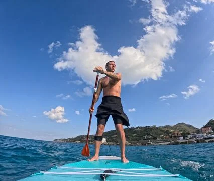 Stand up paddle surf under the clouds Stock Photos