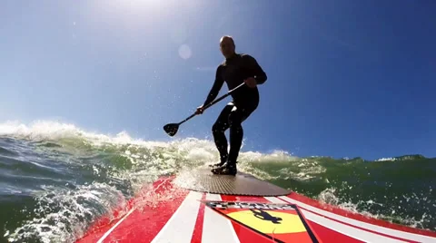 Stand up paddle surfer catches wave-POV Stockbeeldmateriaal 37035938