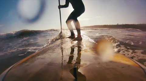 Stand Up Paddle Surfer Catching a Wave at Sunset on the Ocean. Stock Footage 68197304