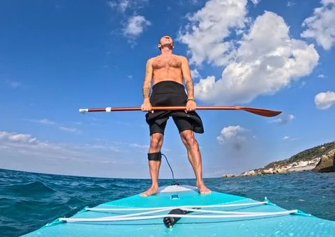 Stand up paddle under the clouds Stock Photos