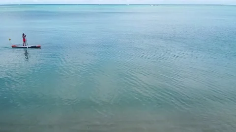 Stand Up Paddleboard in the Ocean 2.5K Stock Footage 147402595