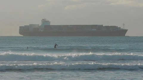 Stand up paddler in ocean container ship in background. Stock-Footage 140962660