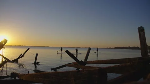 Stand up paddling at sunset Видео 164479121