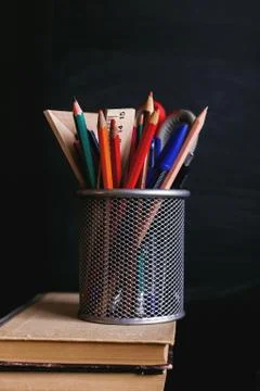 Stand for pens on a stack of books. Stock Photos