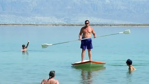 Stand up puddle boarder on the Dead Sea Stock Footage 79392215