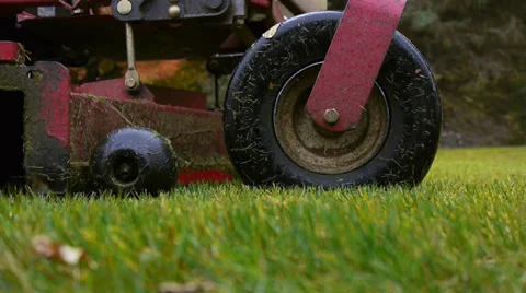 Stand-On Riding Lawn Mower Drives Away on a Rainy Day Stock Footage 37682641