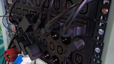 Stand with rows of electrical outlets and power supplies from the devices Stock Footage 71560674