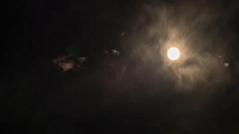 Stand Still Moon Traverses the Sky through Gauzy Skies Stock Footage 283584098