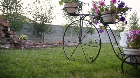 Stand under a flower pot in the form of a bike Stock Footage 83082317