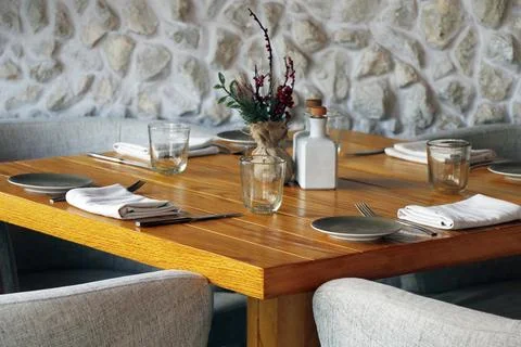 Standard dining table set up for the restaurant with wooden furniture Stock Photos